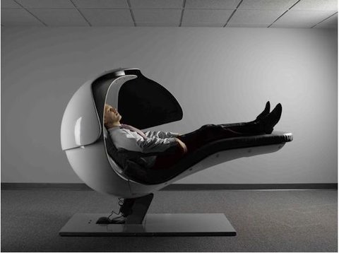 Man reclining in an 'Energy Pod', the Huffington-Post-style napping machine.