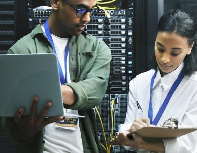 Two Gen Z workers in a server room