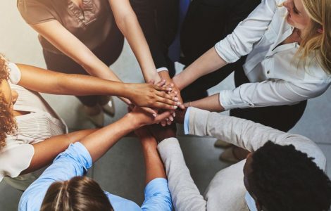 Group of people in a circle with hands together