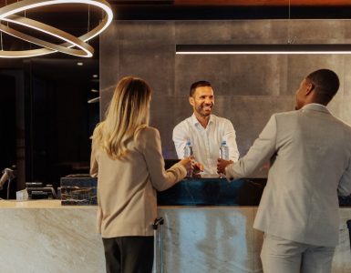 Front Desk of a hotel with receptionist checking in guests